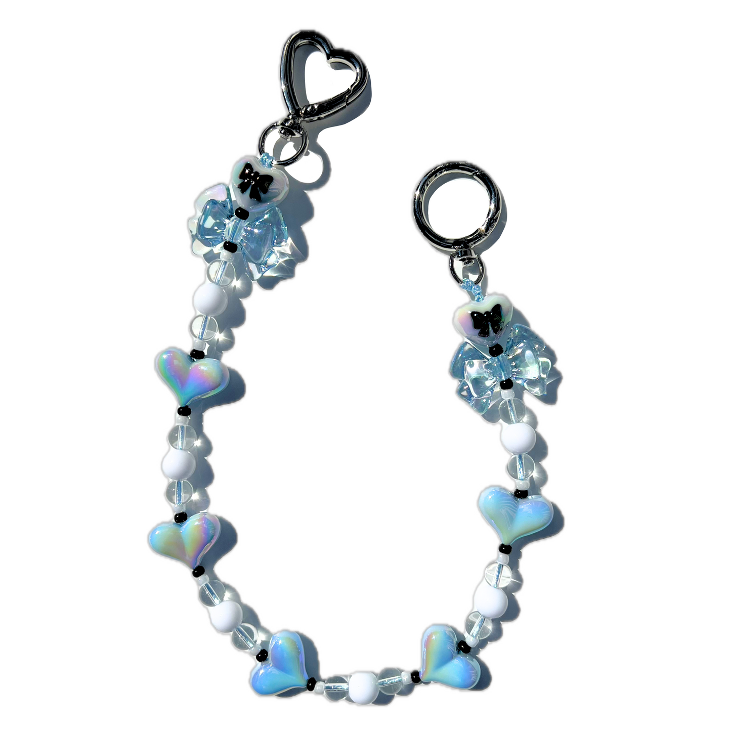 Handmade coquette style baby blue heart and bow bag charm with iridescent beads and silver hardware from SweetKiri.