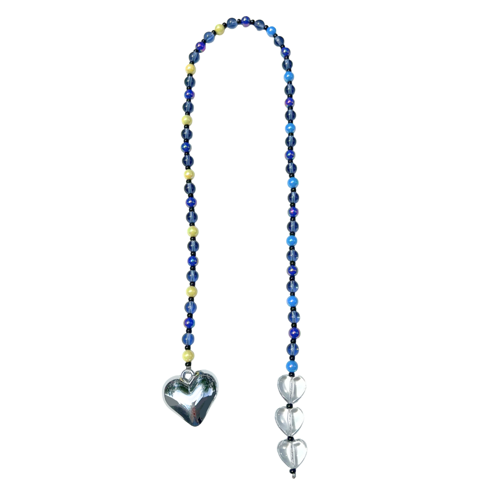 Full view of the Chrome Silver Heart Bag Charm with midnight blue, yellow, and clear beaded accents, featuring a polished silver heart pendant and three clear crystal hearts.