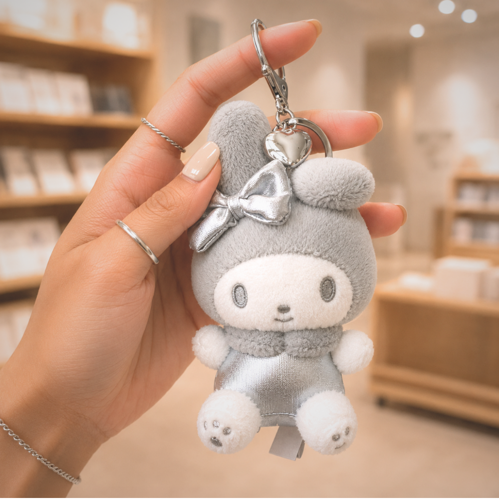 Sanrio My Melody Y2K silver plush keychain bag charm held in hand for size reference