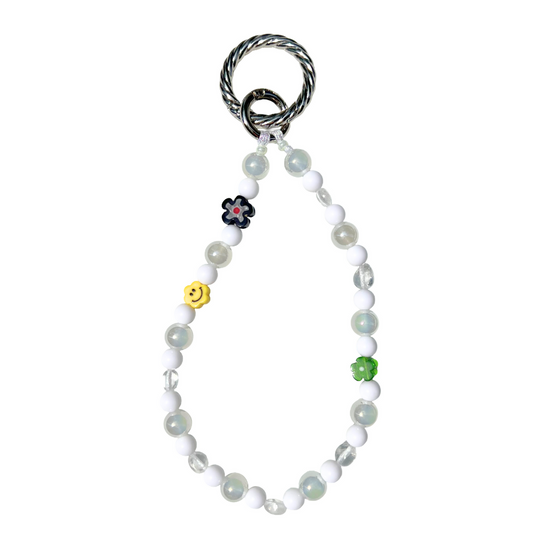 Luminous white eclectic beaded charm featuring milky glass and clear beads, accented with a yellow smiley, green and black flower, finished with a silver twist clasp. Handmade with glass, Czech, millefiori, and acrylic beads.