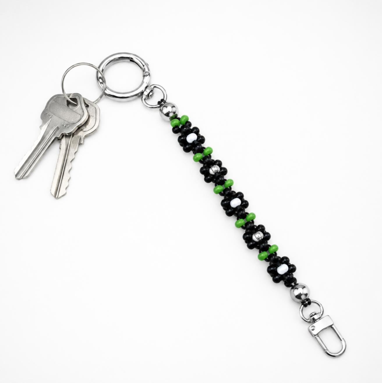 Midnight Daisy handmade beaded keychain shown holding keys – multi-use Czech glass bag charm and ID badge chain Sweet Kiri exclusive