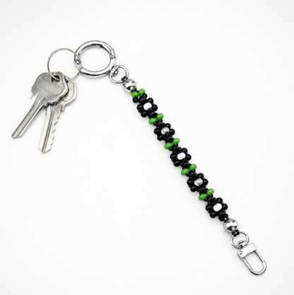 Midnight Daisy handmade beaded keychain shown holding keys – multi-use Czech glass bag charm and ID badge chain Sweet Kiri exclusive