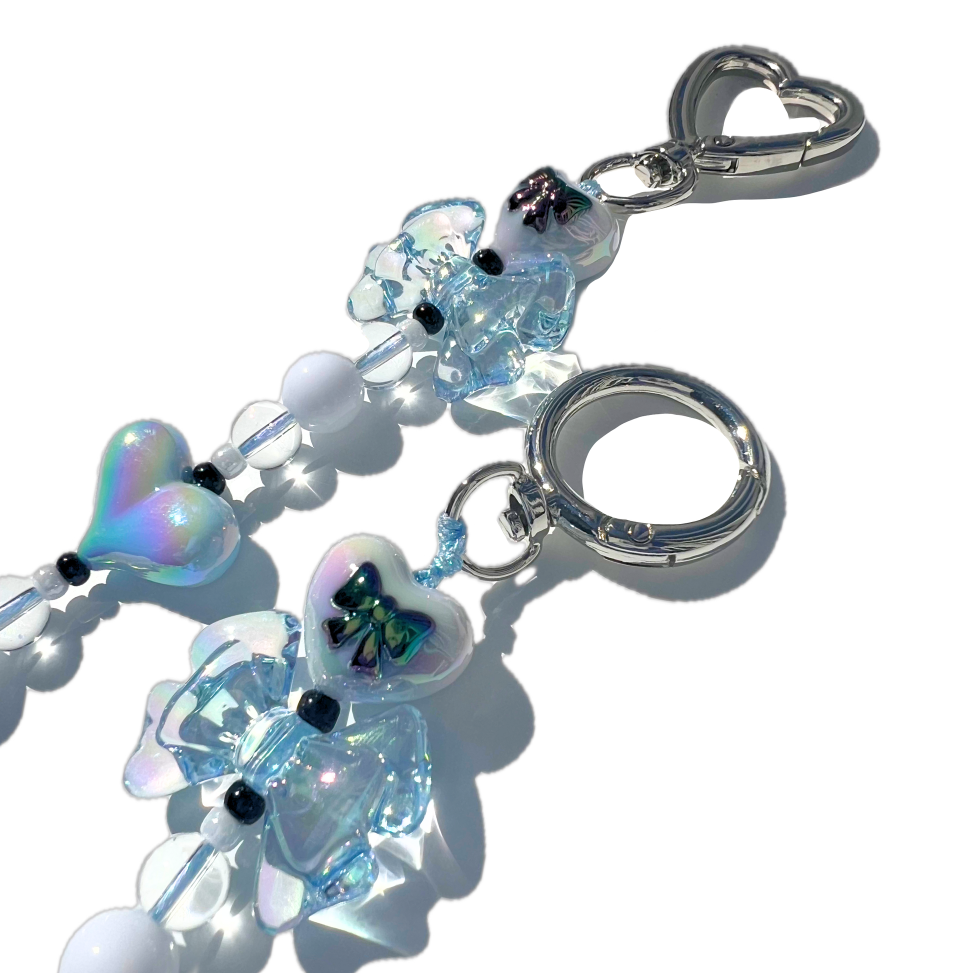 Up close SweetKiri pretty blue bag charm with chunky beads and silver hardware.