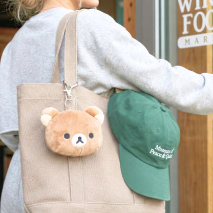 Rilakkuma plush bag charm styled on canvas tote bag, cute Japanese lifestyle accessory for adults