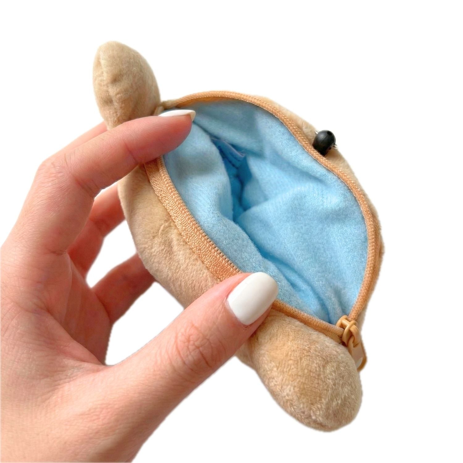 Rilakkuma pouch being unzipped, soft Japanese character keychain with zip pocket