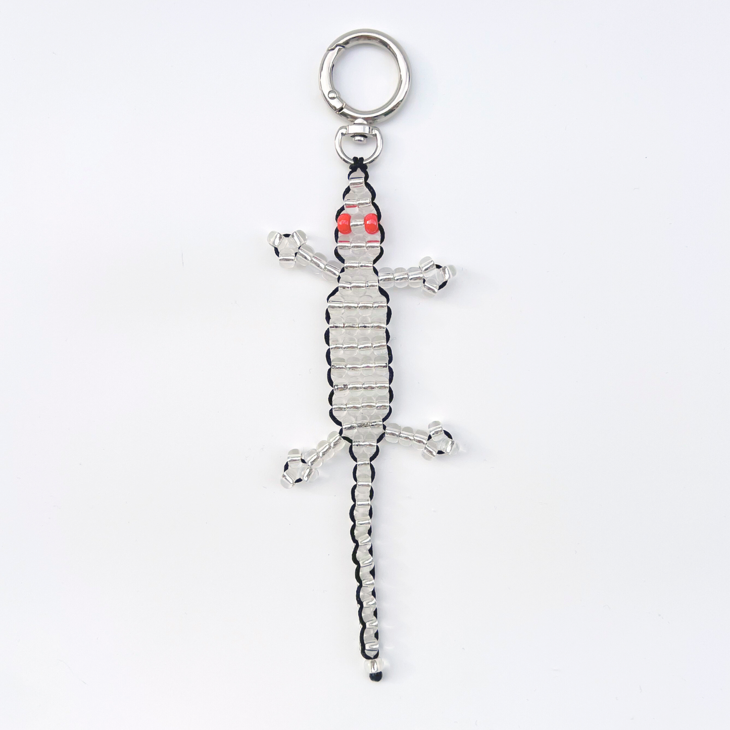 Single silver beaded gecko bag charm with red eyes, photographed front-facing on a white background with metal keyring.