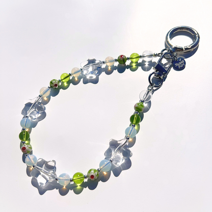 Coastal Muse Tide Pool Green bag charm featuring sea glass green beads, clear glass stars, and silver hardware