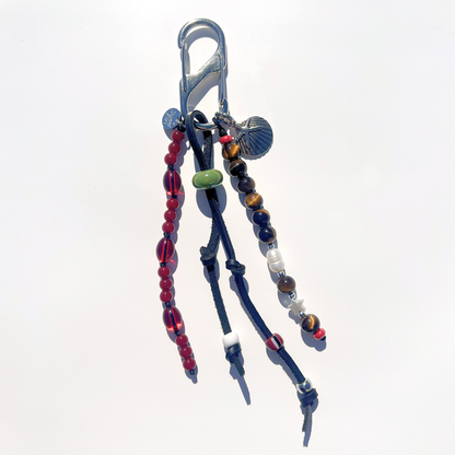 Mariner Relic Tiger Eye & Crimson bag charm with tiger eye stone beads, red glass beads, leather cord accents, and starfish shell pendant