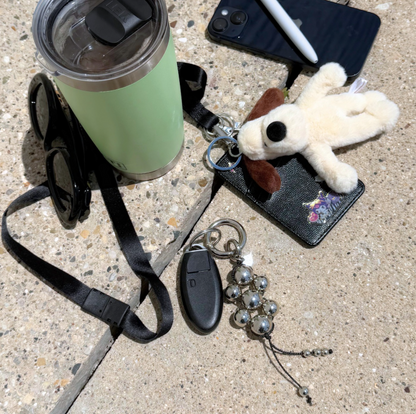 Modern Talisman Chrome Beaded Bag Charm styled with keys, wallet, plush charm, tumbler, and phone, showcasing its everyday carry aesthetic.