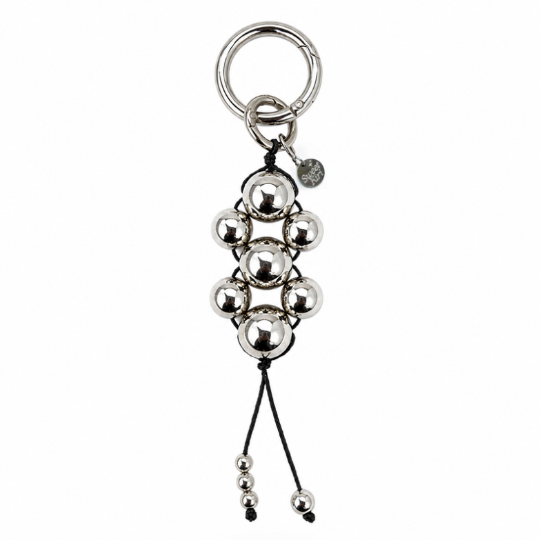 Modern Talisman Chrome Beaded Bag Charm featuring polished chrome spheres handwoven with black cord and a silver keyring.