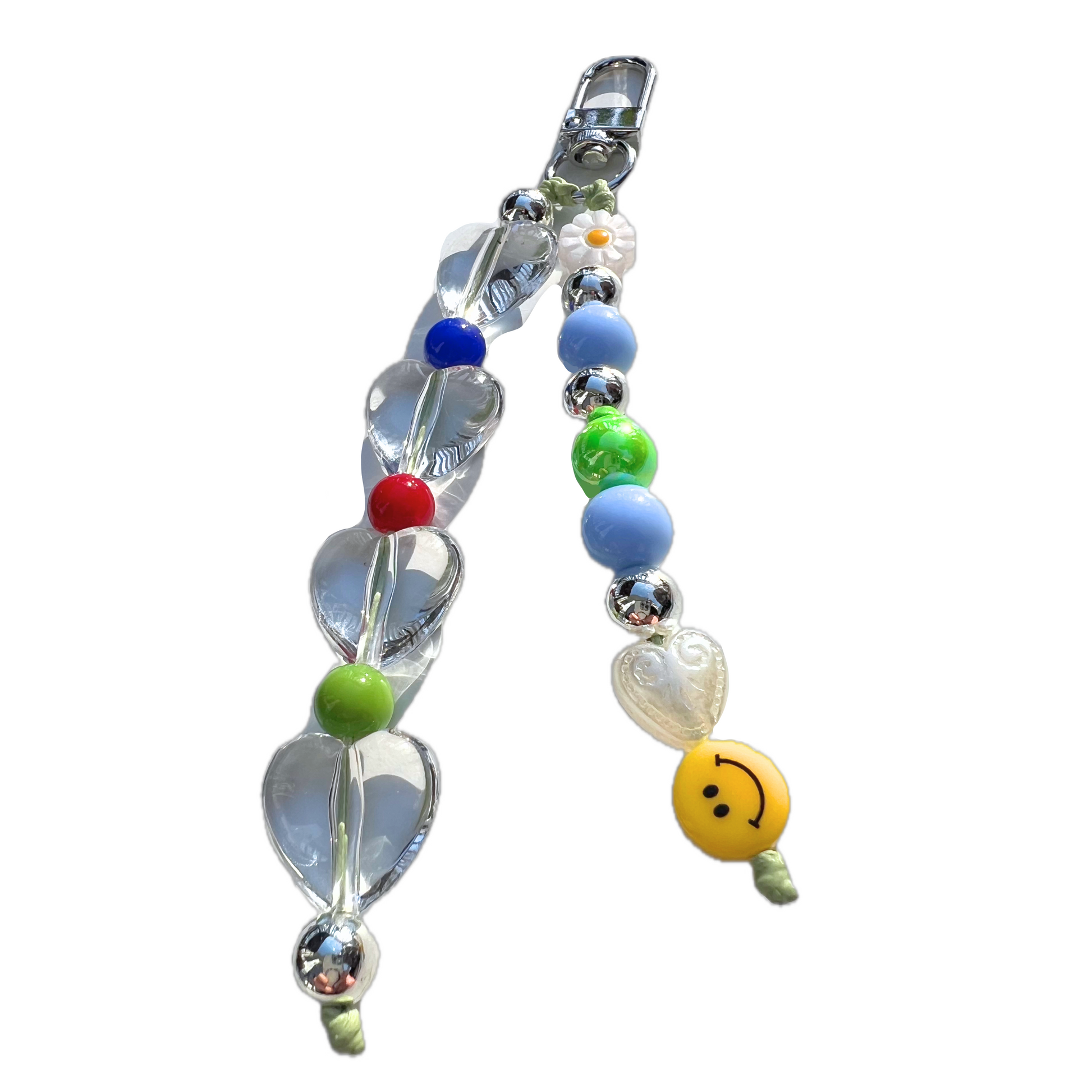 Close-up of handmade beaded bag charm from SweetKiri. Featuring clear heart beads, yellow smiley, daisy flower, and silver keyring clasp