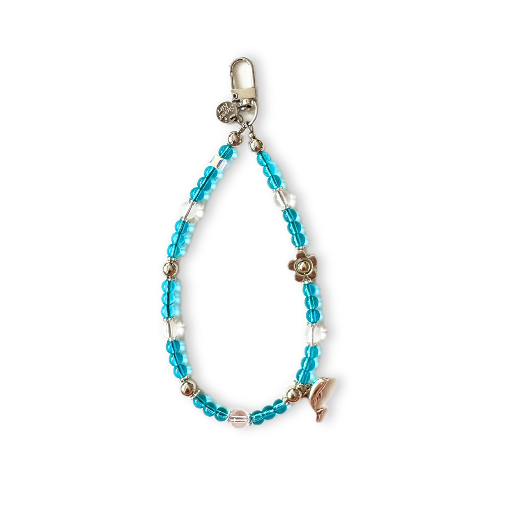 Handmade aqua dolphin beaded phone charm wristlet with turquoise and clear glass beads, a silver flower spacer, dolphin charm and lobster clasp