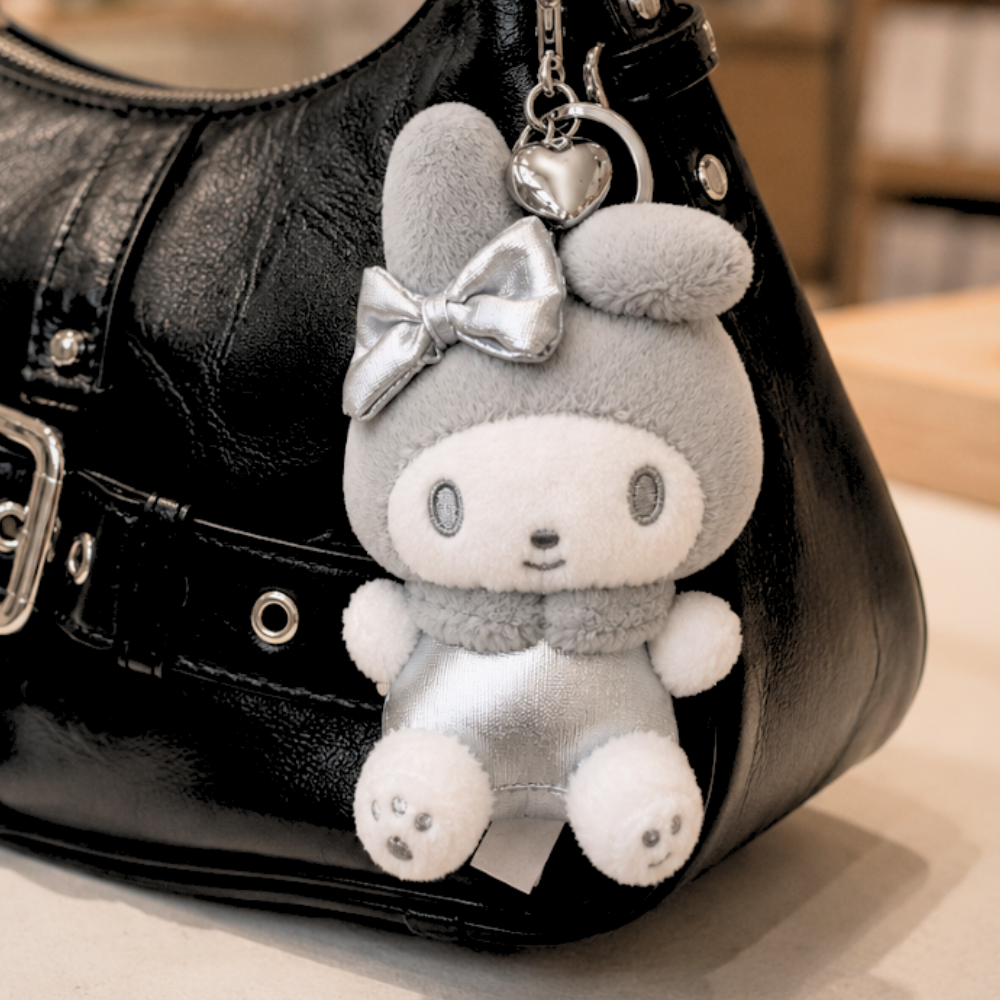 Sanrio My Melody Y2K silver plush keychain attached to a handbag as a kawaii bag charm
