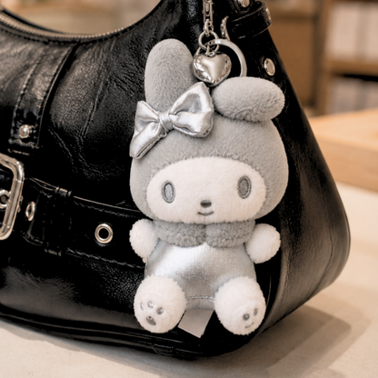 Sanrio My Melody Y2K silver plush keychain attached to a handbag as a kawaii bag charm