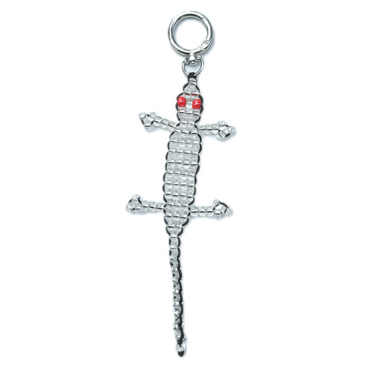 Front view of the Beaded Silver Gecko Bag Charm, a handmade novelty keychain crafted with silver beads and striking red eyes in a lizard design.