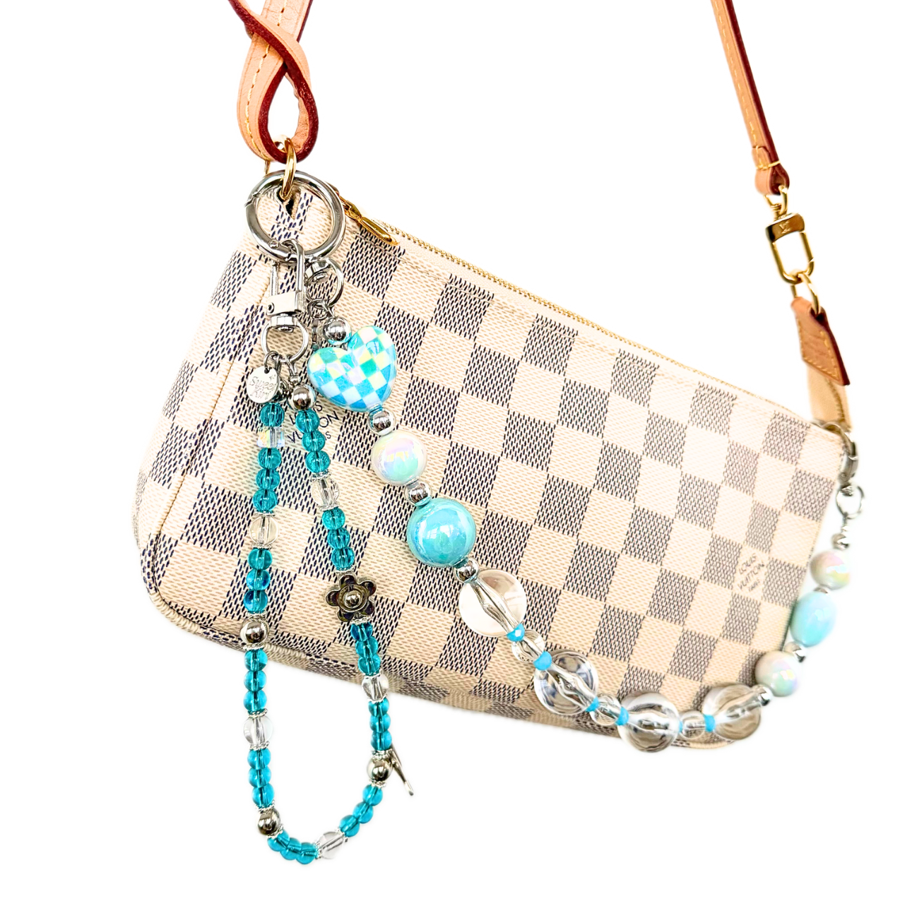 Blue beaded dolphin bag charm clipped to a cream checkered pochette. 
Cute y2k pop star blue bag charm, perfect gift for friends