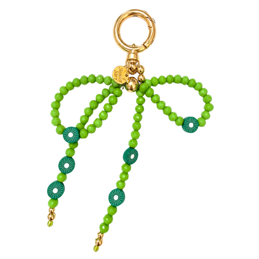 Fresh kiwi green crystal beaded bow bag charm with teal kiwi slice bead accents, gold Sweet Kiri tag and bell — handmade