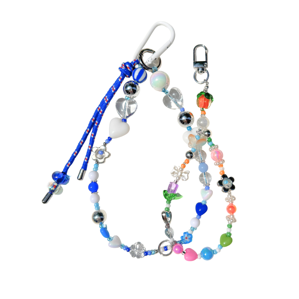 Colorful Garden Party beaded phone charm with persimmon, flower and heart beads, shown beside a blue beaded strap