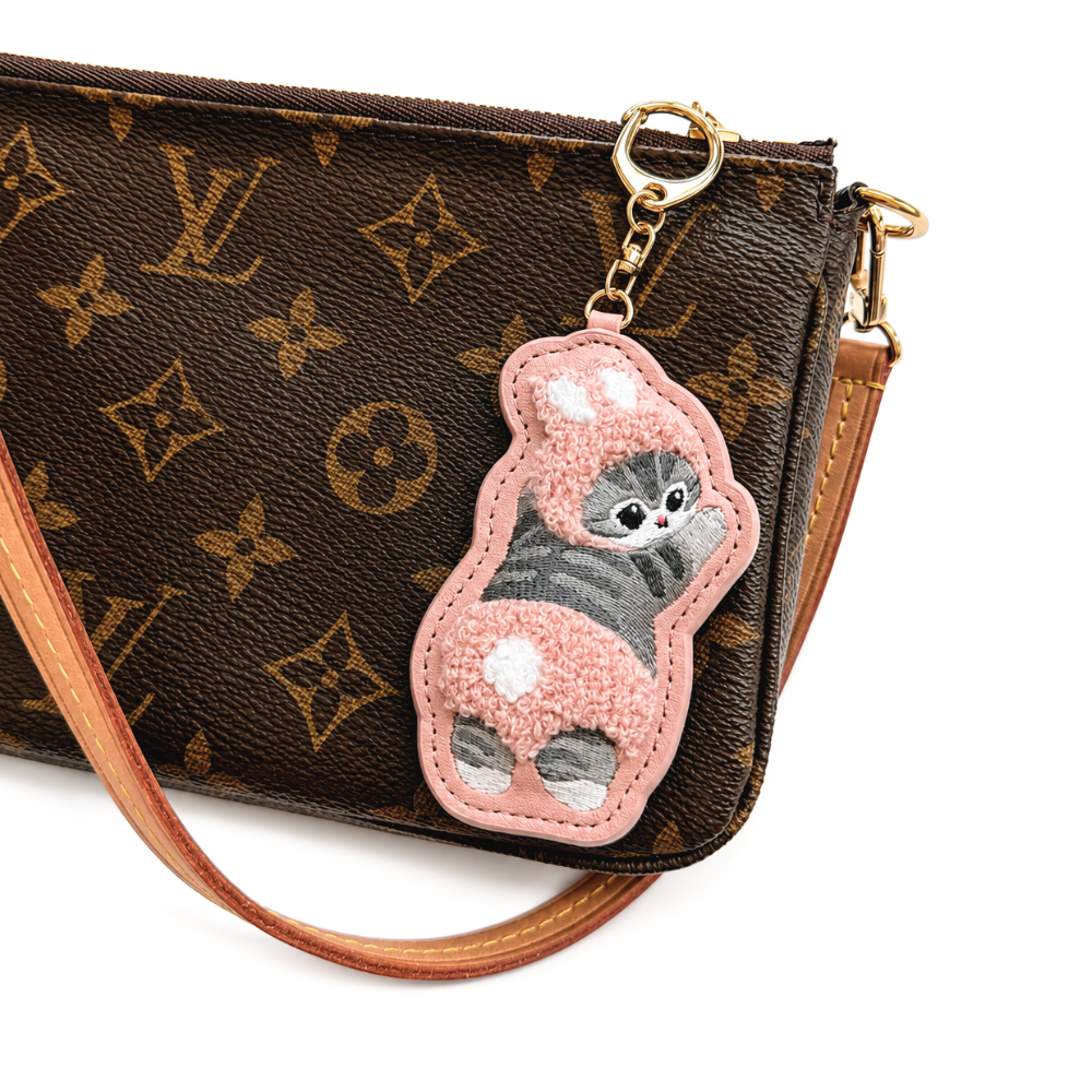 Mofusand pink bunny costume cat embroidered keychain bag charm attached to a handbag with gold-tone clasp