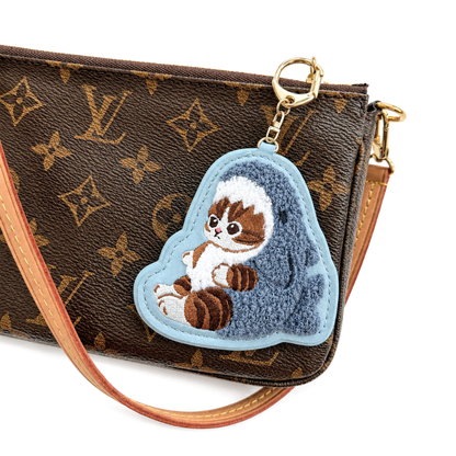 Mofusand shark costume cat embroidered keychain bag charm attached to a handbag with gold-tone clasp
