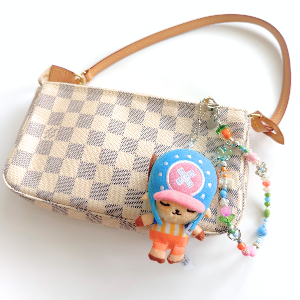 One Piece Tony Tony Chopper plush keychain bag charm attached to a handbag as a cute anime accessory