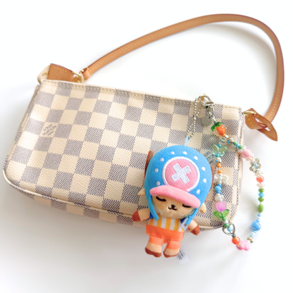 One Piece Tony Tony Chopper plush keychain bag charm attached to a handbag as a cute anime accessory