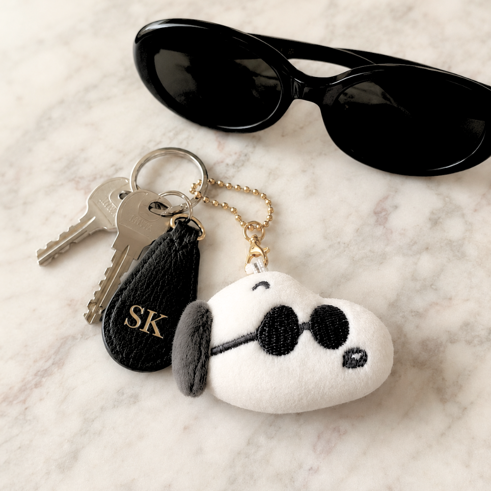Peanuts Joe Cool mini plush keychain attached to keys, shown as a cute everyday bag charm and keychain accessory